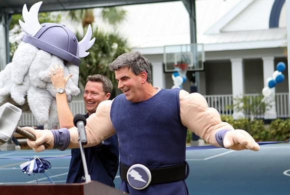 Dennis Chapman helps take David Mahler out of the Thor headpiece of his costume as ODA celebrates new Lower School Athletic Pavilion. Photo by Rachel S. O'Hara