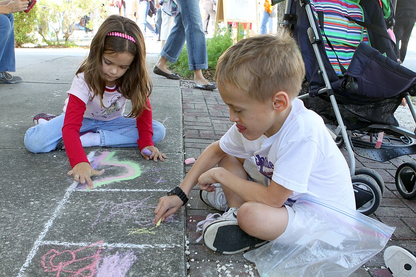 Jennifer Laub and Jack Stanaland, 7, made their own chalk drawings in front of Burns Court Cafe, Saturday, Nov. 5 in Burns Court.