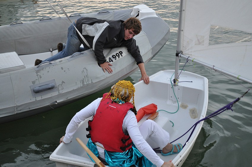 Willa Saalwaechter is given a hand by Sarasota Youth Sailor Brian Firth