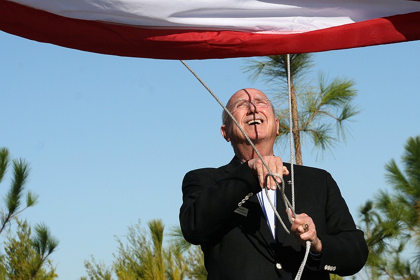 Commissioner and veteran Larry Bustle participated in the flag-raising ceremony.