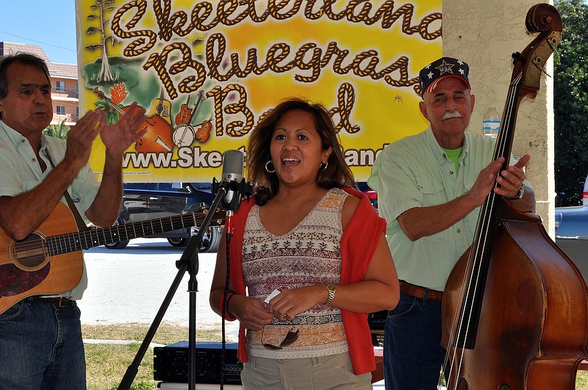 Beverly Arias, organizer for Red Cross' Club Red, speaks to the crowd about donating to the Red Cross.