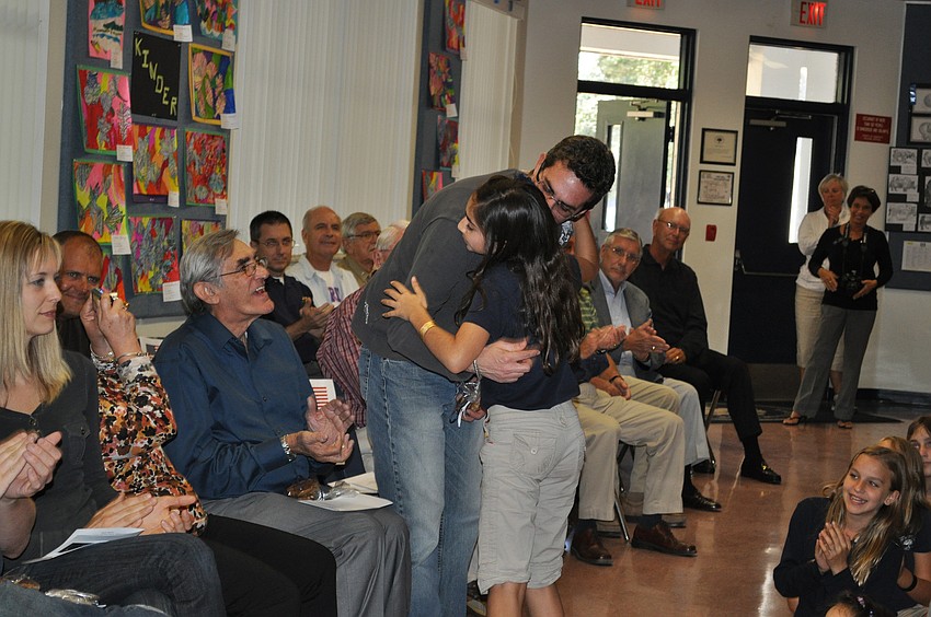 Sophia Delgado presenting to her dad, James Delgado and grandfather, James Delgado, Sr. looks on.