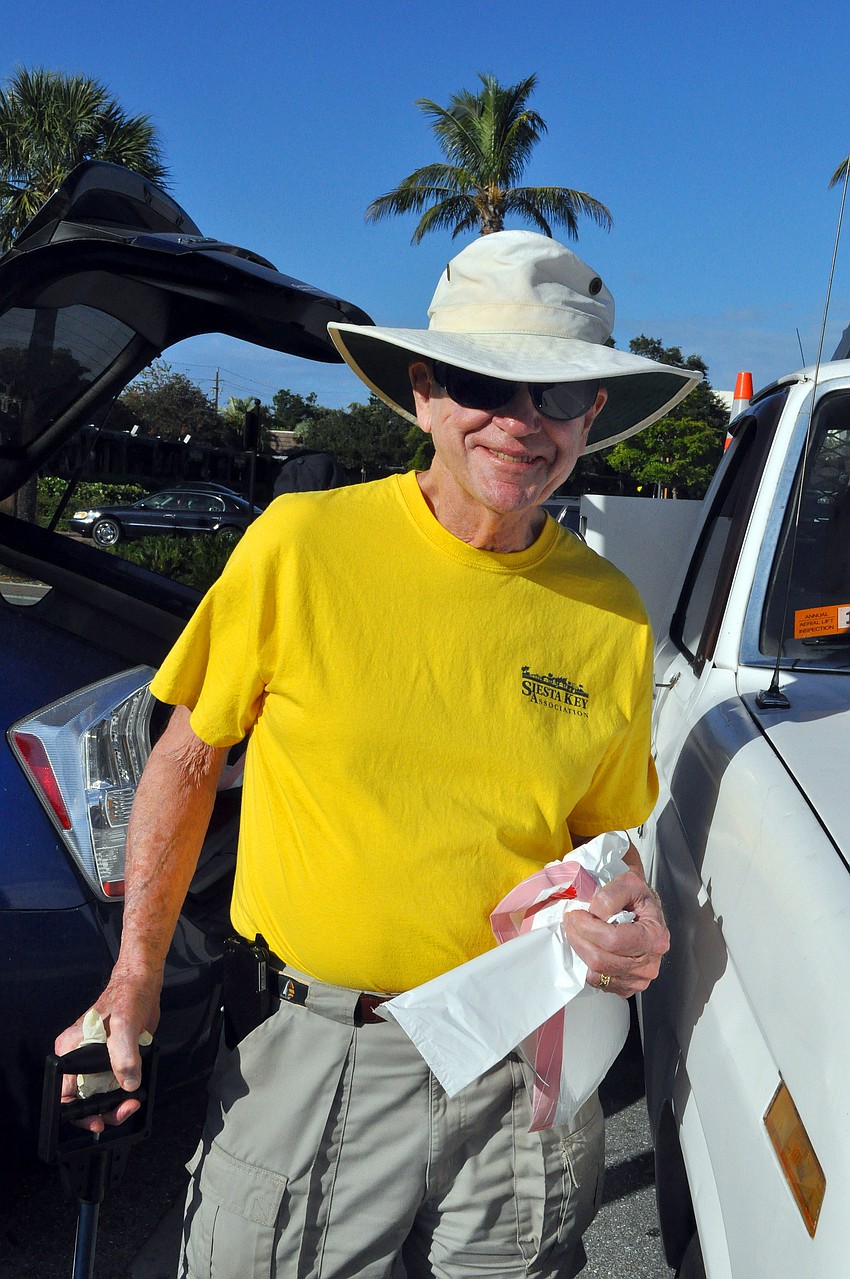 Peter Van Roekens holds a brand new garbage bag that he planned on filling up while cleaning up Ocean Boulevard.