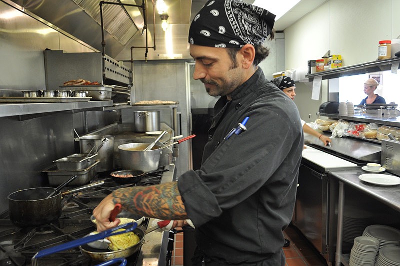 Line cook Douglas Jennings prepares breakfast for patrons at Station 400.