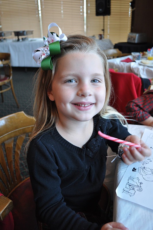 Lauren Gross, 5, enjoyed a candy cane after her breakfast.