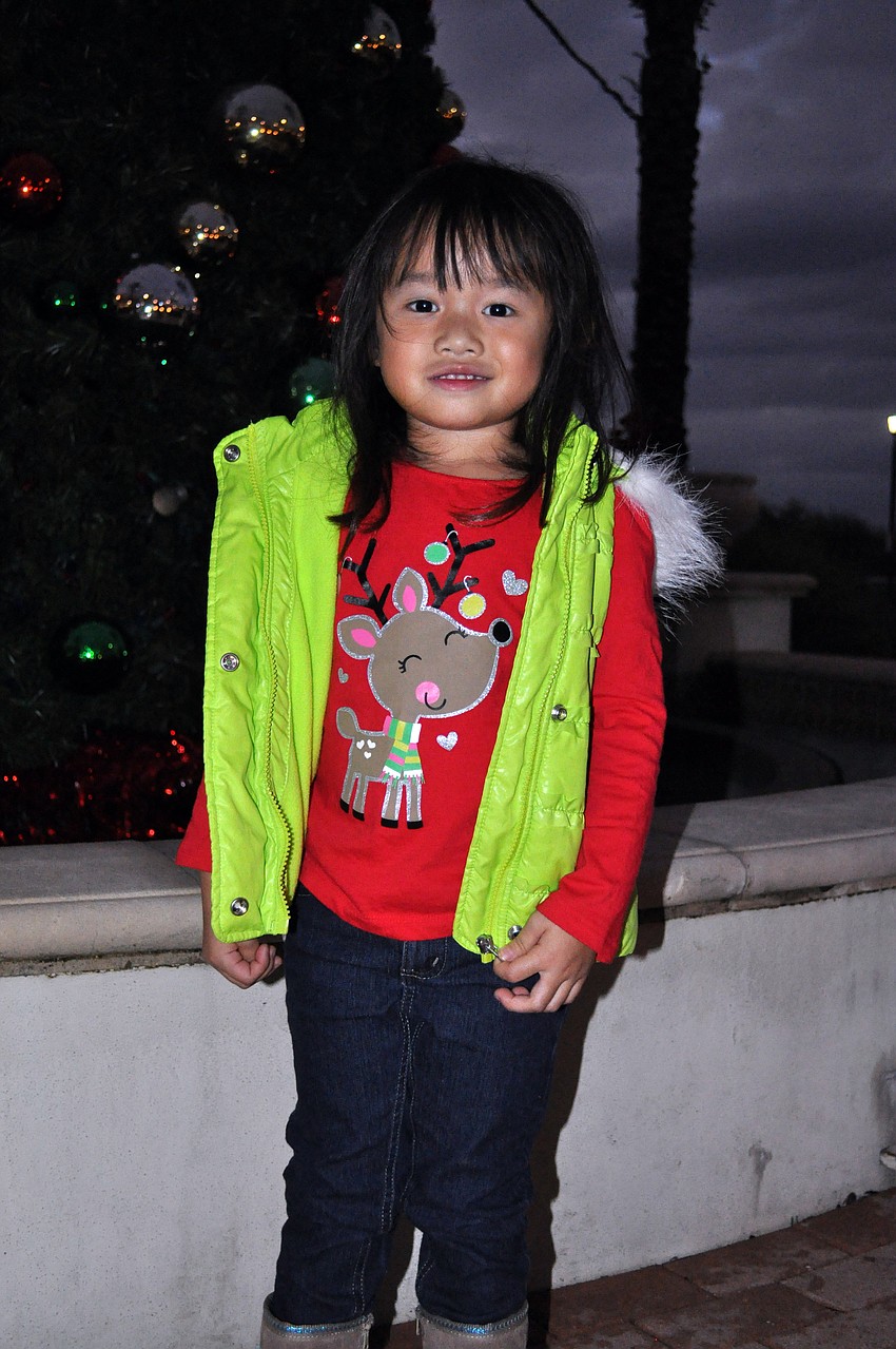 Three-year-old Taryn Nguyen made sure to stop by the Christmas tree.