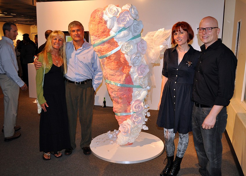 Susan and Tom Chappel pose with Amy Williamson Miller and Kenneth Miller next to one of Williams Millerâ€™s pieces during the opening of THIRTEEN, Friday, Dec. 9, at G Wiz.