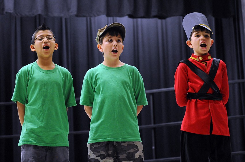 Toy soldiers Arlin Rodriguez, Michael Schmidt and Dylan Welch made sure the toys were cleaned and fixed in time for Christmas.