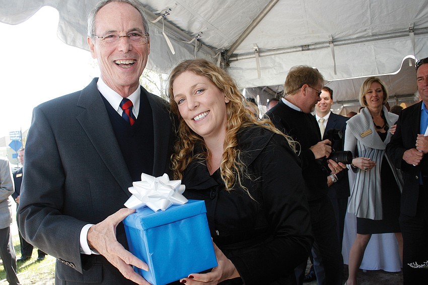 Neal Communities President Pat Neal, right, threw a party for resident Lauren Acton, who purchased Neal's 8,000th home. Published March 17, 2011.