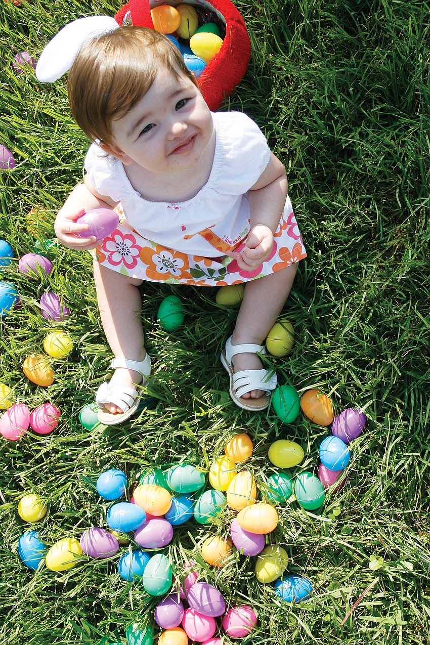 Kylee Davis, 1, took her time selecting her Easter eggs at the Harvest United Methodist Church hunt. Published April 28, 2011.
