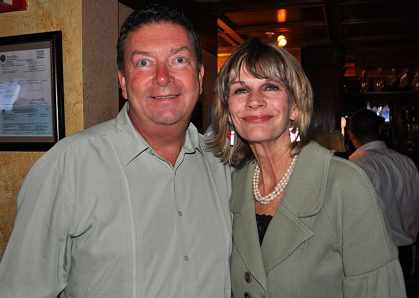 Phil Chmieleski and Mayor Suzanne Atwell pose together, Thursday, Dec. 15, during the DSA holiday party at the Irish Pub on Main.