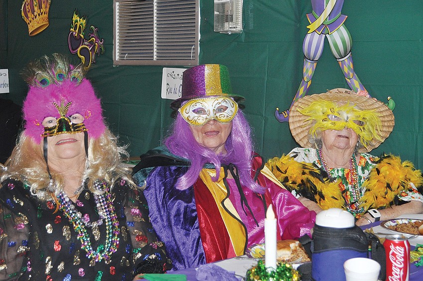 Jackie Winter, Ellen Laurent and Chartlotte Barsalow donned their Mardi Gras finest in February for Gulfshore of Longboat Keyâ€™s Mardi Gras party.