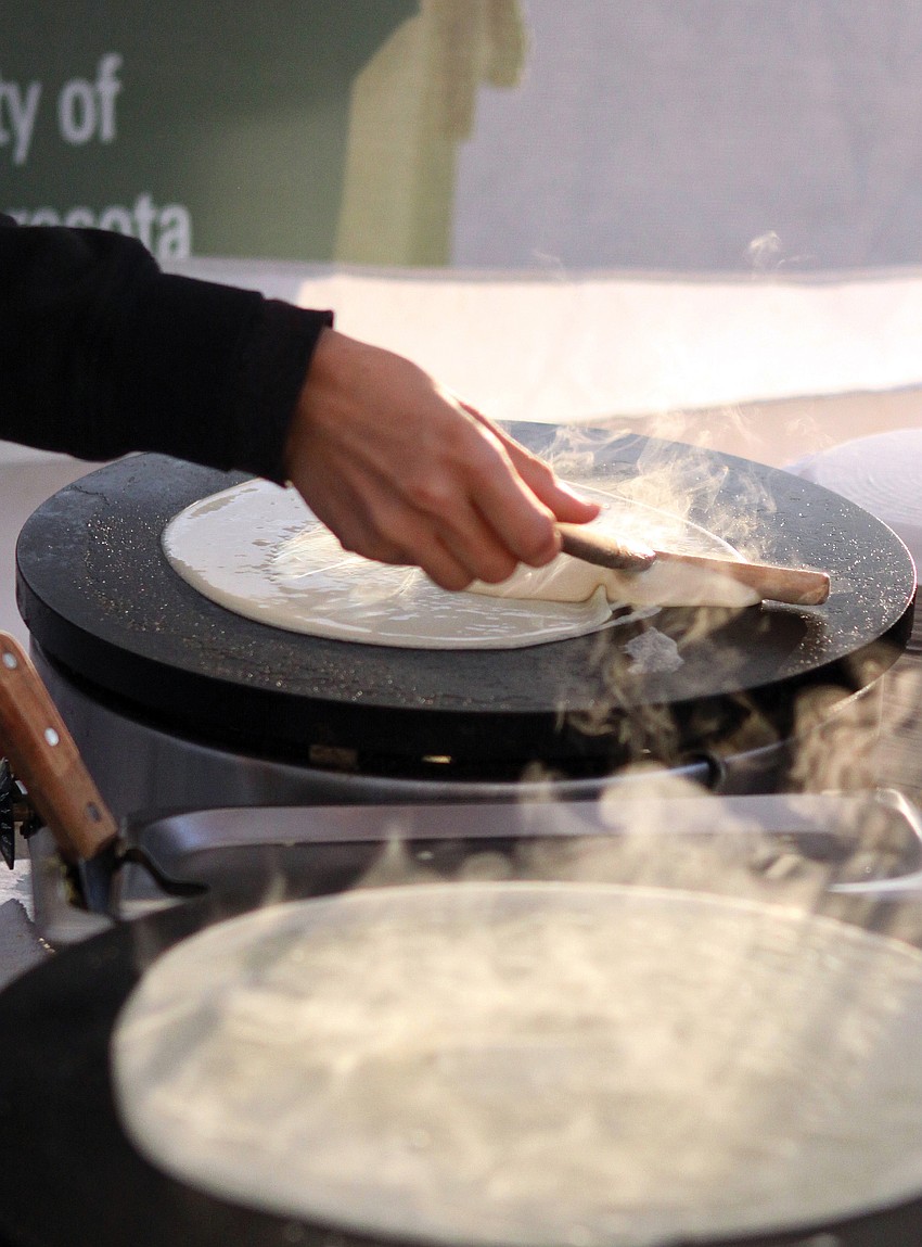 Natalia Winn makes fresh crepes at Rovertaâ€™s Crazy Crepes stand in January at the Sarasota Farmers Market.