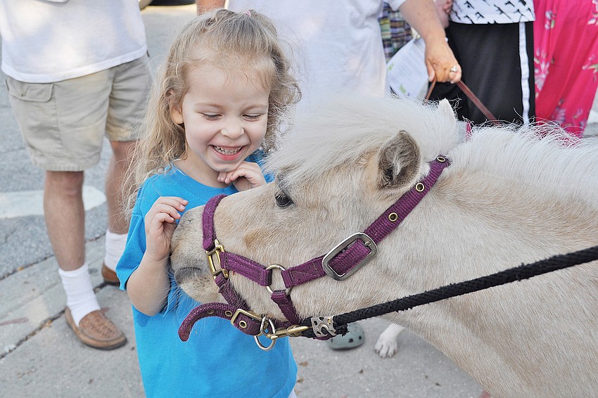 Brooke Wolfinger got a smooch from Rodney, a miniature horse, in April at Humane Society of Sarasota Countyâ€™s Smooches for Pooches Stroll.