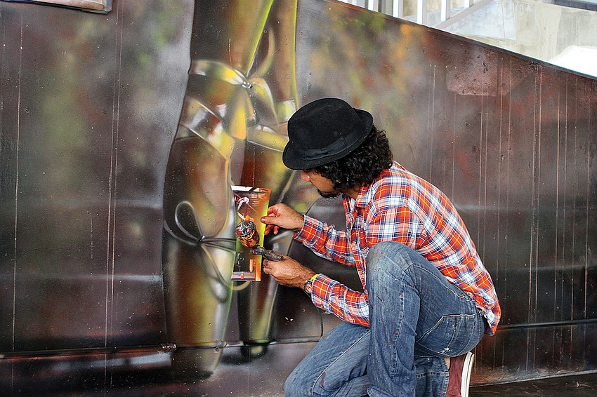 Eduardo Kobra, from Sao Paulo, Brazil, worked on some finishing touches to ballet slippers that he and his team from Studio Kobra created in November on the second-floor walls of the Palm Avenue parking garage.