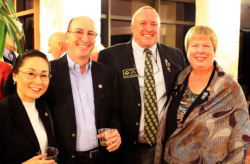 Yoko and Tom Cappiello with Steve and Pam Schlueter pose together, Tuesday, Jan. 3, inside the USF Sarasota-Manatee FCCI Rotunda.