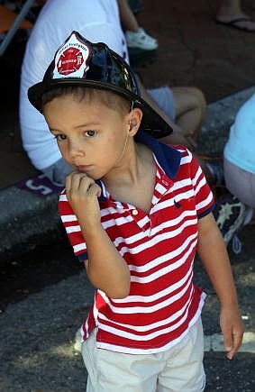 Martin Oâ€™Malley, 3, watches the fire trucks go by Sunday, Sept. 11, during the Remembrance March.