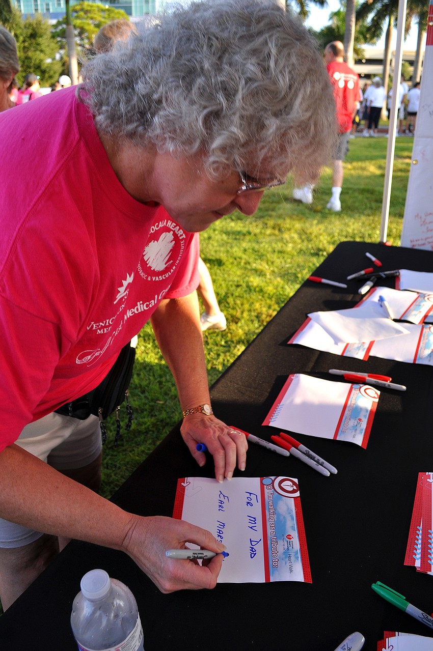 Edna MacIver writes out whom she is walking for Saturday, Sept. 24, for the Sarasota/Manatee Heart Walk at Payne Park.