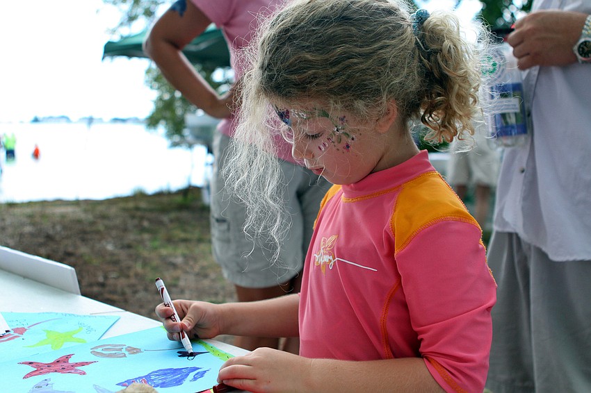 Kate Carver, 6, drew a picture of the ocean with stencils and colored markers.