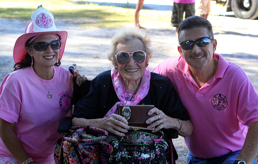 Joanne Hampton and Merv Kennell pose with Irene Walas, 93, who was the first female fire civilian in Pawtucket, RI. Walas carries around her badge in her wallet.