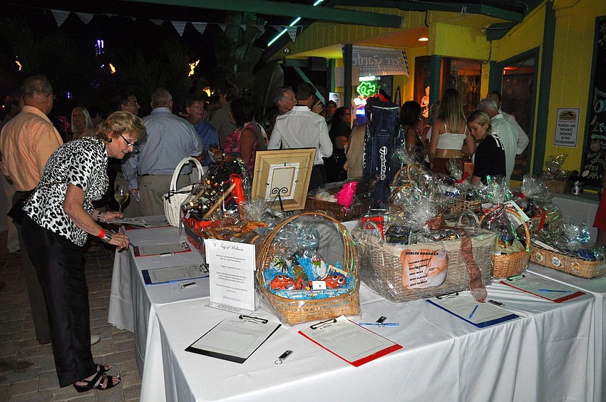 People gathered around the silent auction tables and enjoyed the nice night outside Thurday, Oct. 6 during the 11th annual Okto-Paw-Fest at the Daiqiuri Deck on SIesta Key.