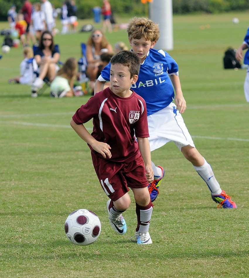 Nine-year-old Collin Golden brings the ball up the field while searching for an open teammate.