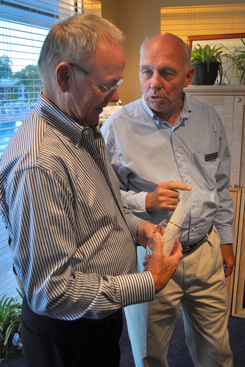 Jim Hanes listens to Blair McCracken explain how the beer tasting and rating system work.