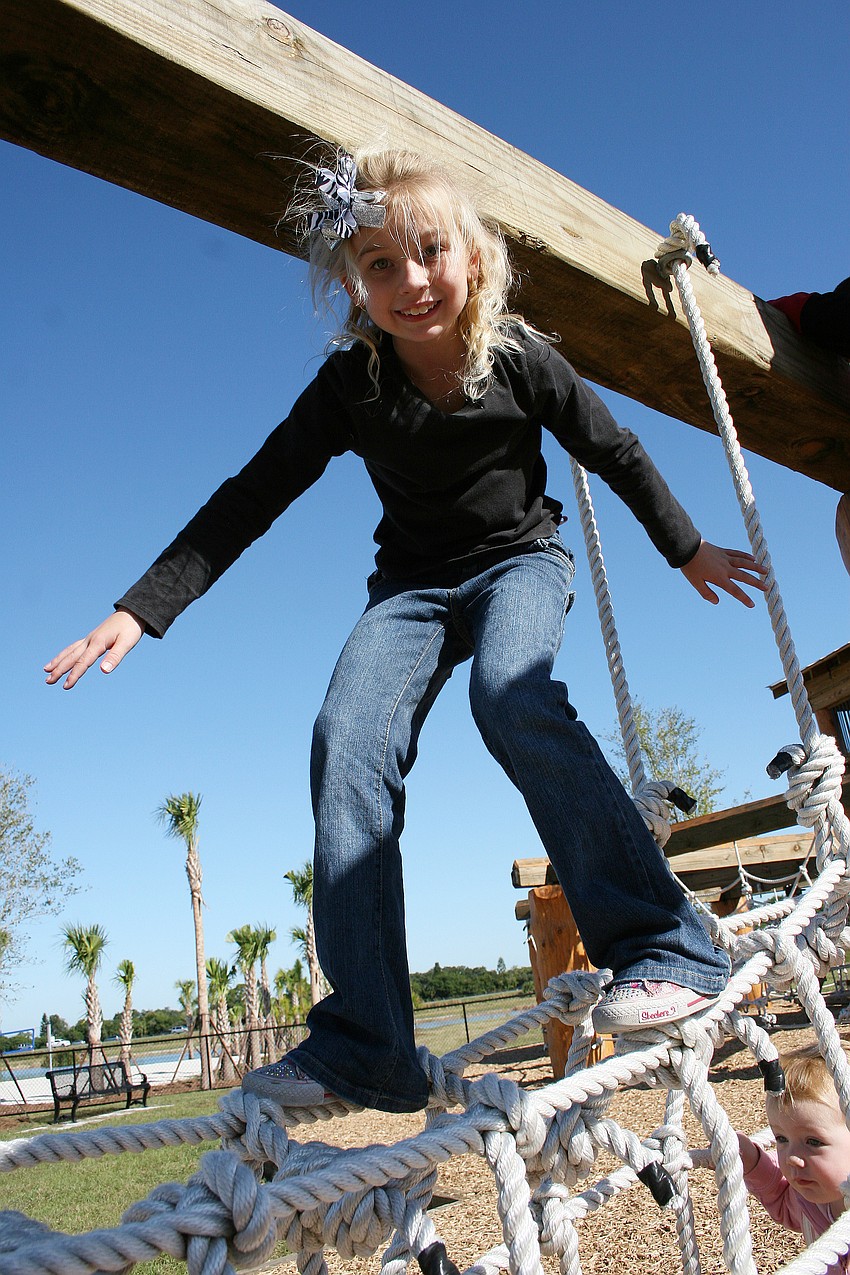 Caleigh Bennett, 8, had no trouble balancing atop the rope bridge.