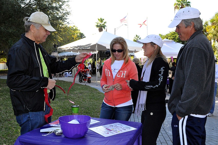 Jim Shedivy works on tearing off raffle tickets while Sharon Schwalm, Susan Seth-Ward and Rob Donath wait to buy them.