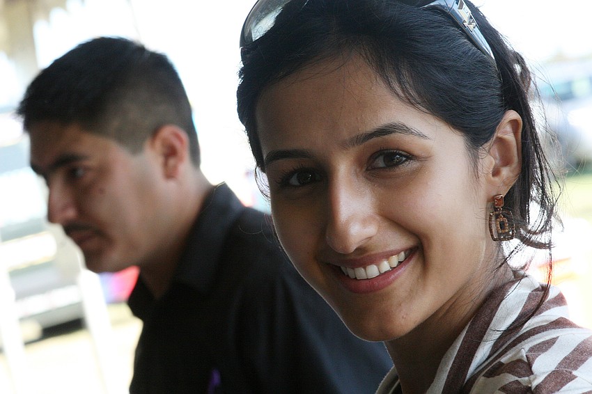 Sheena Maini, right, and Noe Espinoza offered Indian cuisine at the booth for Tandoor Indian Restaurant.
