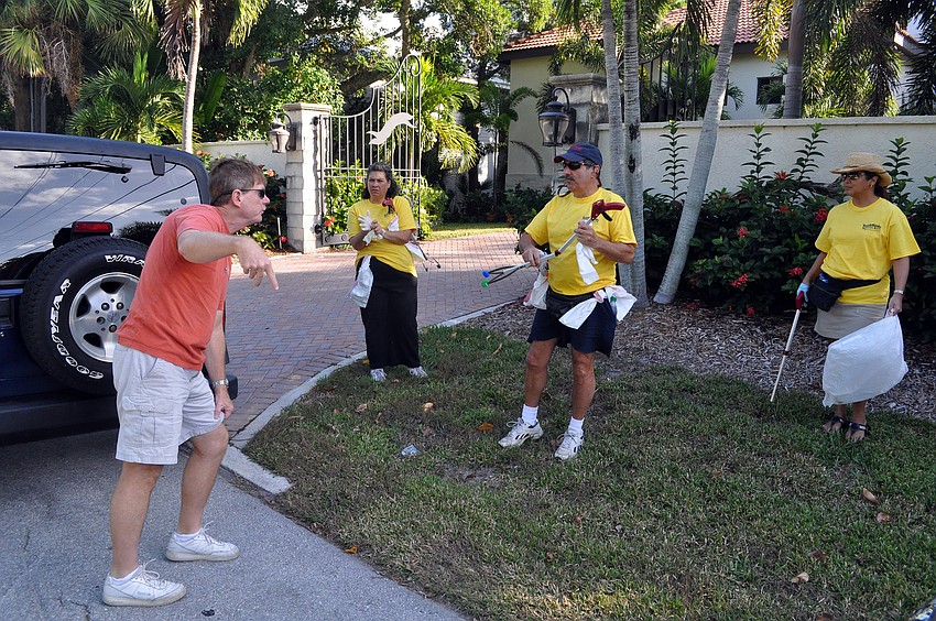 Mark Smith drops off Maria and Michael Shay and Beverly Arias before heading off to take another group to their designated clean up area.