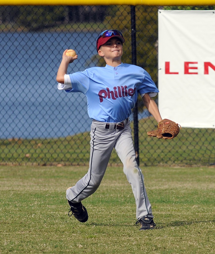 Ten-year-old Calvin Hedgepeth warms up before the start of the Philliesâ€™ championship game versus the Red Sox.