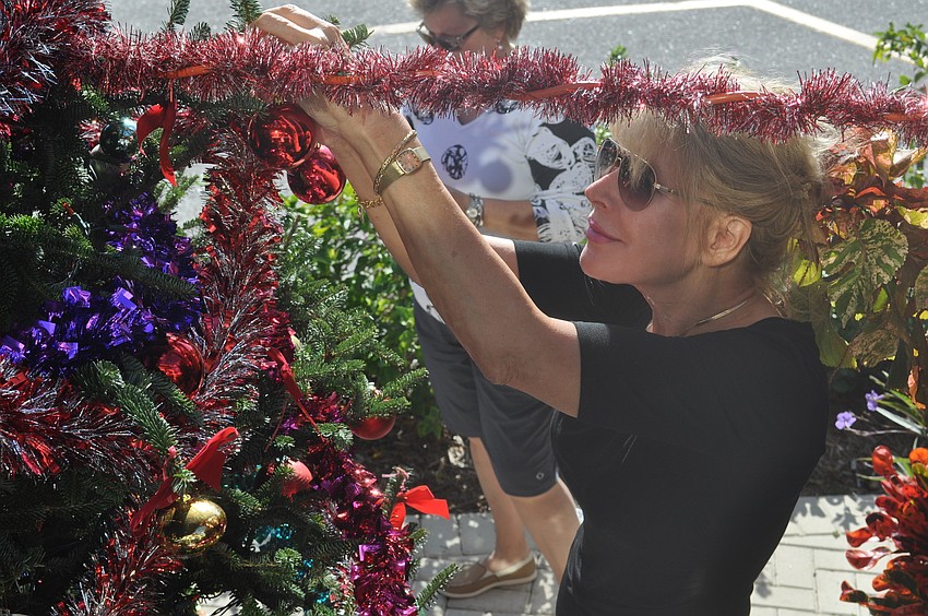 Diane Waldeck hangs an ornament