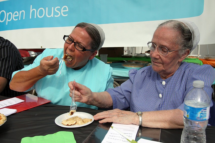 Sherry Gore and Amanda Yoder share a piece of one of the 21 pies entered into the during the 1st annual pie contest, Friday, Dec. 9 at Everence Federal Credit Union.