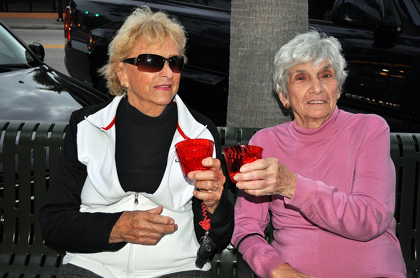 Jane Bertolett and Nancy Wilkinson toast one another, Friday, November 9, during Southside Stroll.