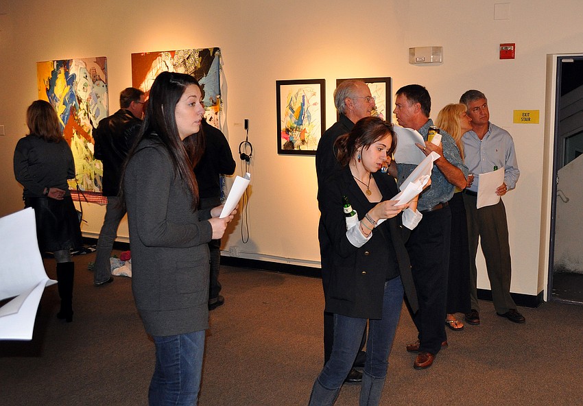 People wandered around the upstairs of G Wiz checking out the art done by the artists affiliated with S/Art/Q during the opening of THIRTEEN, Friday, Dec. 9, at G Wiz.