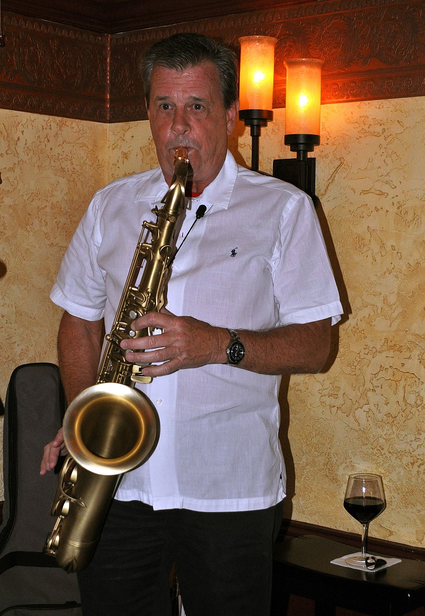 Harry Fager, of 2 Saxy, plays the saxophone, Thursday, Dec. 15, during the DSA holiday party at the Irish Pub on Main.