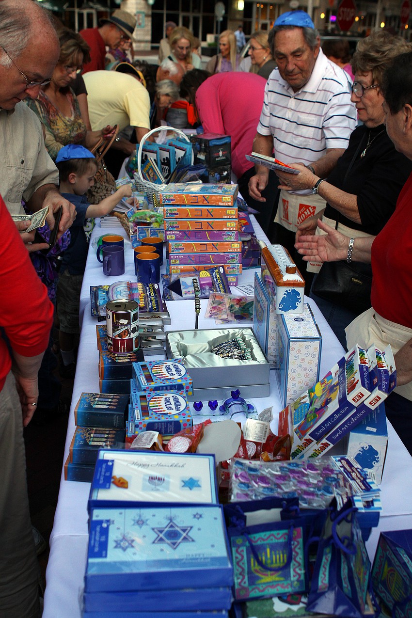 A long table full of Chanukah gifts and traditional Chanukah toys were for sale at A Taste of Chanukah.