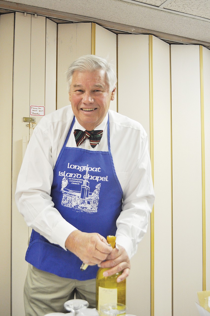 John Holtermann prepared to pour drinks in January at the Longboat Island Chapelâ€™s international-themed dinner.