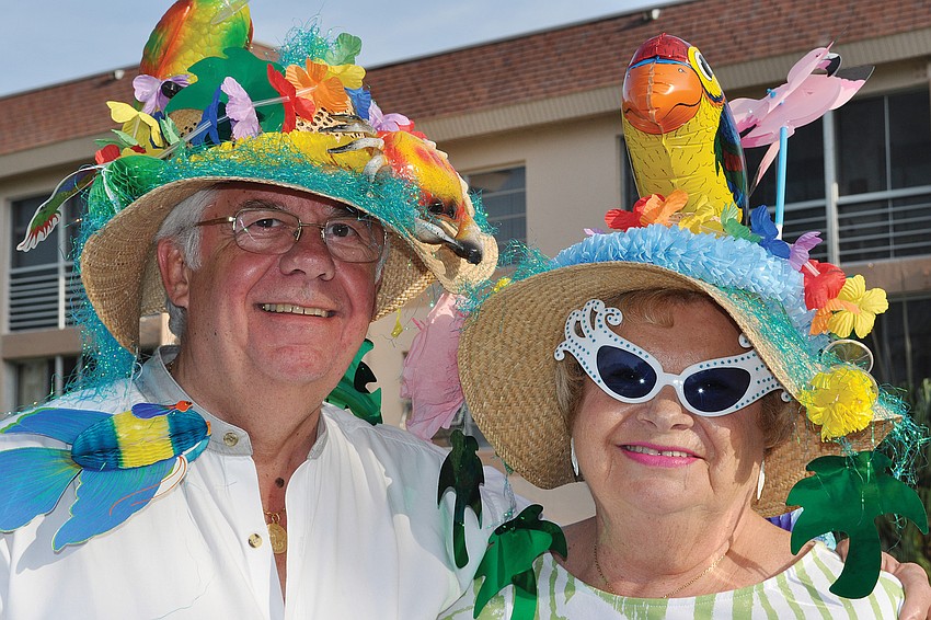 George and Carol Beddie wore their Parrothead finest to Longboat Harbour Northâ€™s Jimmy Buffett-themed pool party in April.