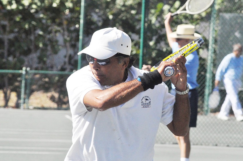 Gewen D. Maharaj waits for the ball from Joe Bouquin during the December CAT II Senior Clay Courts tournament at the Longboat Key Public Tennis Center.