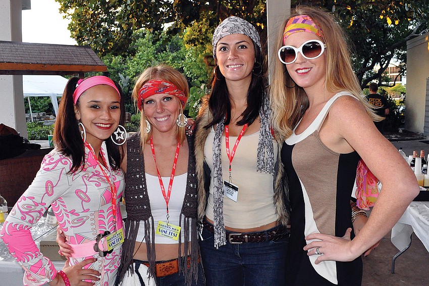 Seana Doyle, Stacy Gonzalez, Samantha Coyle and Rachel Matthes worked the bar in their â€™70s attire during the Siesta Key Chamber of Commerceâ€™s annual Sandfest fundraiser.