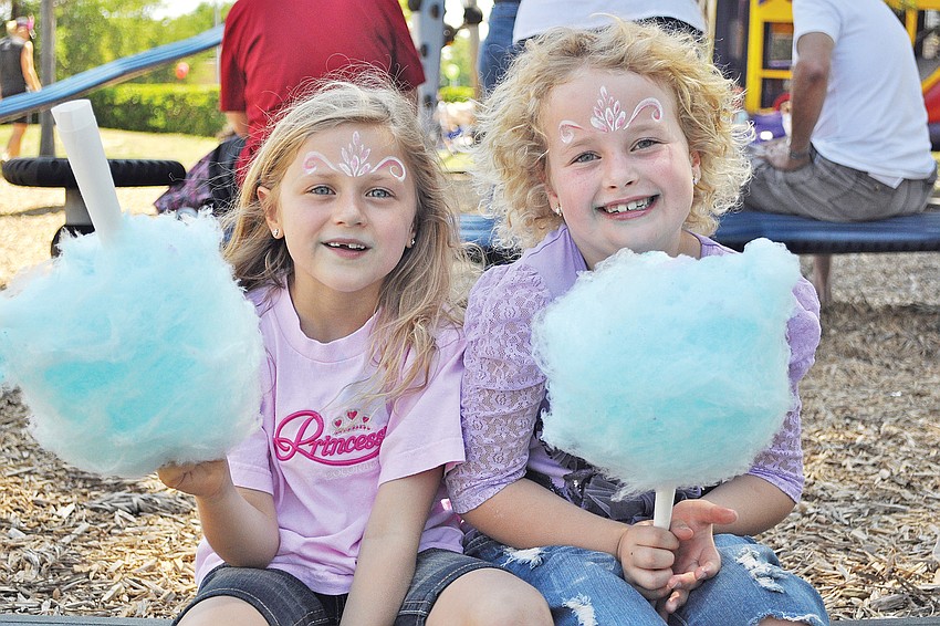 Lindsay Bennett and Gabrielle Bennett enjoyed cotton candy in March at Temple Beth Sholomâ€™s Purim Carnival.