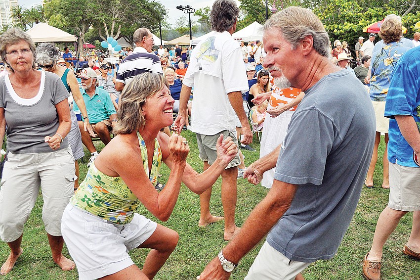 Cynthia and Keith Wilson get into the music, performed by Yesterdayze in July, at Friday Fest, held on the lawn at the Van Wezel Performing Arts Center.