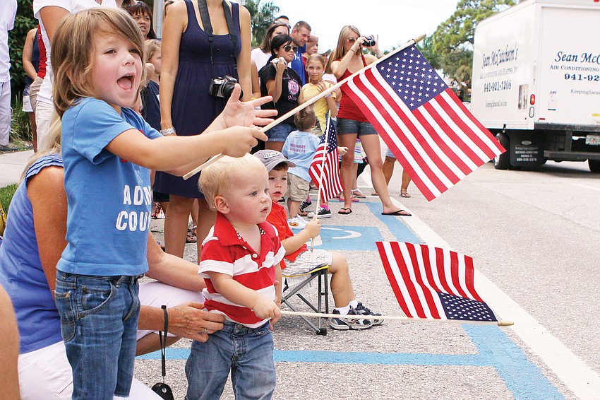 Brittin Sullivan, 4, and Ridge Sullivan, 1, waited to see their uncle walk by with the rest of the Sarasota County firefighters Sept. 11, during the remembrance march, organized by the Sarasota Firefighters Benevolent Fund.