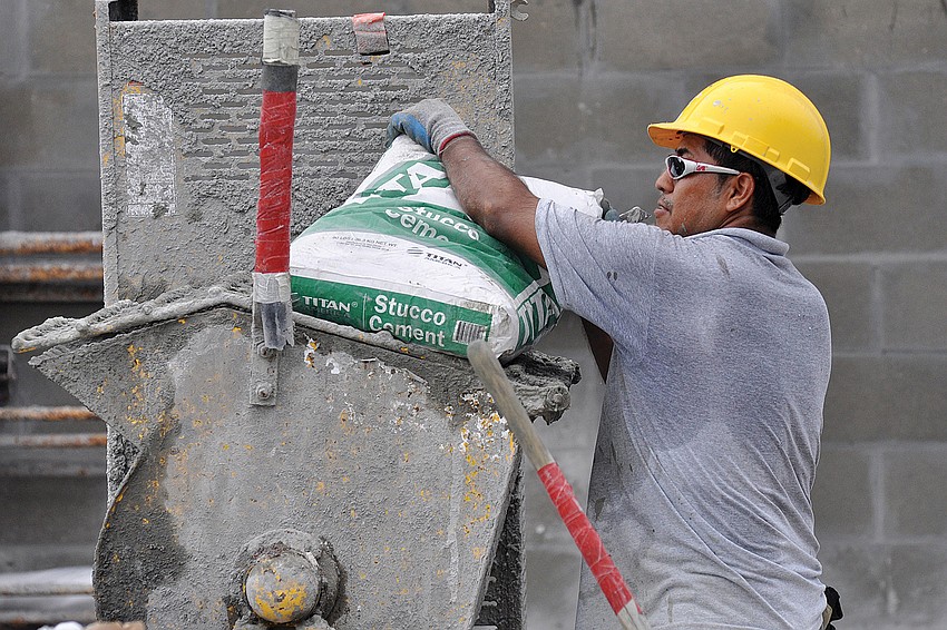 David Garcia Espinoza, of Parsons Stucco, mixes materials together for the walls of Goodwill Industriesâ€™ new donation center in Lakewood Ranch.