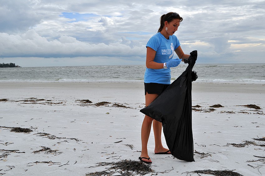 Lindsay Price cleans up South Lido Thursday, Sept. 8, at Ted Sperling Park.