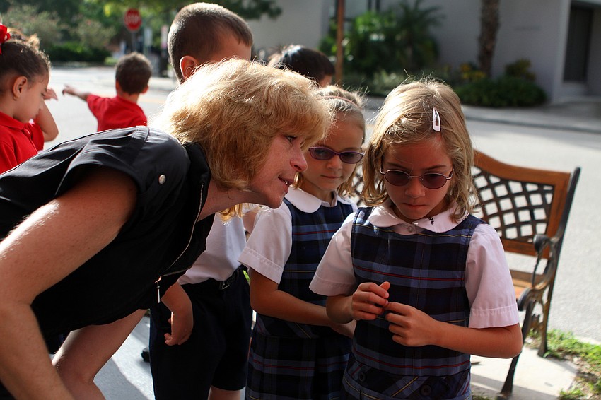 Beth Duda talks to Cathlin Caldas, 7, about the show the children are about to see Tuesday, Sept. 27 at the Gompertz Theatre.