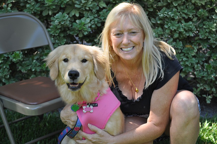Suzanne Byron poses with her eight-month old dog, Lucy. Byron wants her dog to have protection.