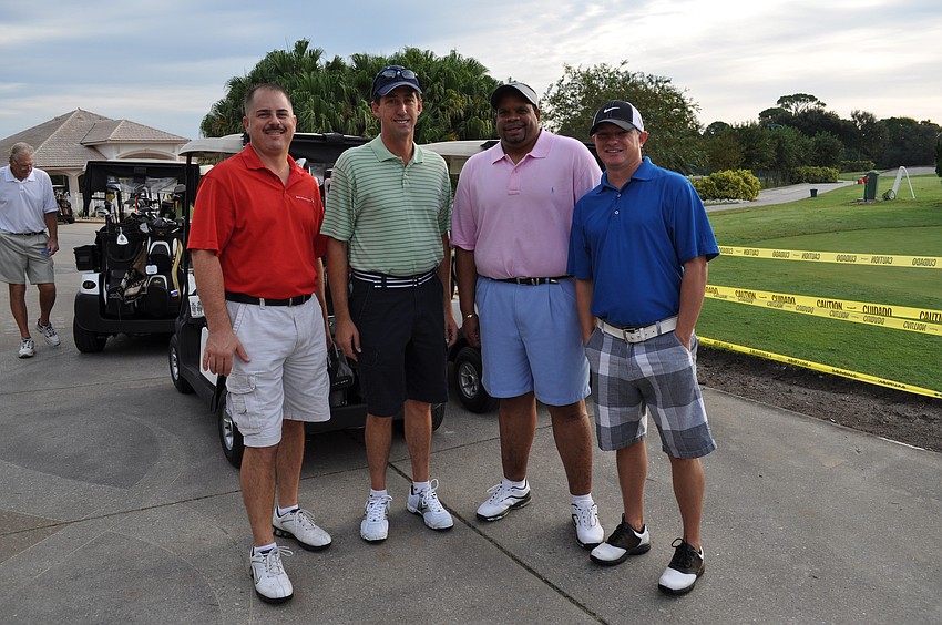 Sponsors of the BMW prize at hole six and employees for BMW of Sarasota Brian Dounan, Ed Seymour, Charles Wilson and Carey Paige.